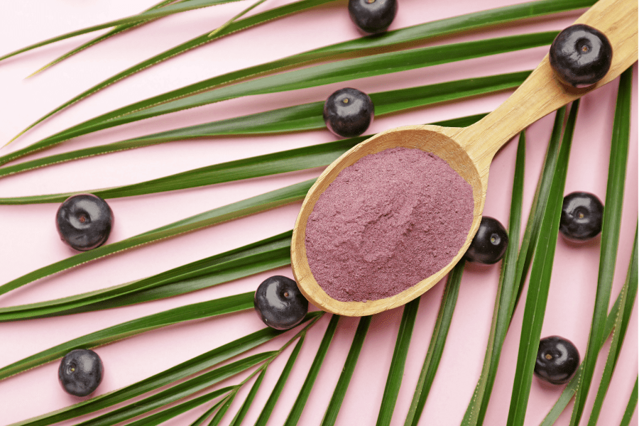 A wooden spoon with purple powder on it